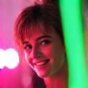 Profile picture of Chloe, a young adult with a bright, energetic smile, possibly at a festival with blurred lights in the background.