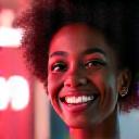 Portrait of a resilient, diverse community organizer with a warm smile, dynamic background lights.